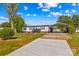 Charming single-story home with ample parking, canopy, and manicured lawn under a bright, sunny sky at 114 Doubletree Dr, Statesville, NC 28677