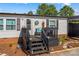 Charming front porch with dark wood stairs, decorative accents, and a cozy seating area at 114 Doubletree Dr, Statesville, NC 28677