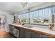 A cozy kitchen featuring laminate countertops, a window over the sink, and gray cabinets at 114 Doubletree Dr, Statesville, NC 28677