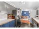 Well-organized kitchen showcasing stainless steel appliances, gray and blue cabinetry, and seamless connectivity at 114 Doubletree Dr, Statesville, NC 28677