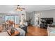 Bright living space featuring laminate floors, a dining area, modern TV, and lots of natural light at 114 Doubletree Dr, Statesville, NC 28677
