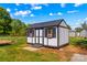 An outdoor shed with windows and a door, providing storage solutions in a well-maintained backyard at 114 Doubletree Dr, Statesville, NC 28677