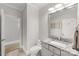 Modern bathroom with gray vanity, granite countertop, updated fixtures, and tile flooring at 127 N Tryon St # 511, Charlotte, NC 28202