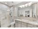 Modern bathroom with double vanity, glass shower, and tiled walls at 127 N Tryon St # 511, Charlotte, NC 28202