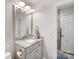Contemporary bathroom with gray vanity, granite countertop, updated fixtures, and a tiled shower at 127 N Tryon St # 511, Charlotte, NC 28202