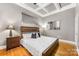 Cozy bedroom with hardwood floors, tray ceiling, and stylish decor at 127 N Tryon St # 511, Charlotte, NC 28202