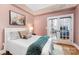 Comfortable bedroom featuring a plush white bed, soft grey pillows, and a blue throw blanket with natural lighting at 127 N Tryon St # 511, Charlotte, NC 28202