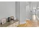 Hallway view with hardwood floors, light-gray walls, and a side table at 127 N Tryon St # 511, Charlotte, NC 28202