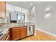 Modern kitchen features stainless steel appliances, granite countertops, and wooden cabinets at 127 N Tryon St # 511, Charlotte, NC 28202