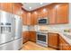 A kitchen featuring stainless steel appliances, light gray countertops, and dark wood cabinets at 127 N Tryon St # 511, Charlotte, NC 28202