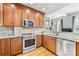 Modern kitchen features stainless steel appliances, granite countertops, and wooden cabinets at 127 N Tryon St # 511, Charlotte, NC 28202