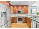 Modern kitchen features stainless steel appliances, granite countertops, and wooden cabinets at 127 N Tryon St # 511, Charlotte, NC 28202