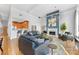 Spacious living room with blue accent wall, hardwood floors, open floorplan and kitchen at 127 N Tryon St # 511, Charlotte, NC 28202