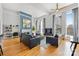 A spacious living room with large windows, hardwood floors, and modern decor at 127 N Tryon St # 511, Charlotte, NC 28202