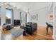 Bright and spacious living room with hardwood floors, large windows, and modern decor at 127 N Tryon St # 511, Charlotte, NC 28202