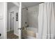 Bathroom featuring a tiled shower and tub combination, along with an open doorway and neutral color palette at 130 Cherokee Ln, Salisbury, NC 28147