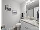 Bathroom featuring a single sink, white cabinets, granite countertop, framed art, and a toilet at 130 Cherokee Ln, Salisbury, NC 28147