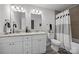 This bathroom features a double vanity, modern lighting, and tiled floors at 130 Cherokee Ln, Salisbury, NC 28147