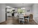 Bright dining room with hardwood floors, a round table, and a view into the kitchen at 130 Cherokee Ln, Salisbury, NC 28147