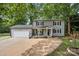 Charming two-story home with a covered front porch, an attached garage, and a well-manicured lawn at 130 Cherokee Ln, Salisbury, NC 28147