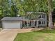 Charming home with a two-car garage, inviting front porch, and lush landscaping at 130 Cherokee Ln, Salisbury, NC 28147