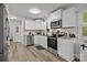 Modern kitchen with stainless steel appliances, granite countertops, and hardwood flooring at 130 Cherokee Ln, Salisbury, NC 28147