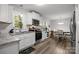 Bright and open kitchen and dining area, featuring stainless steel appliances, white cabinets, and wood floors at 130 Cherokee Ln, Salisbury, NC 28147