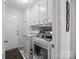 Laundry room featuring white washer and dryer, cabinets, and an ironing press at 130 Cherokee Ln, Salisbury, NC 28147