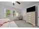 This is the main bedroom with a ceiling fan, dresser, and lots of light from the windows at 130 Cherokee Ln, Salisbury, NC 28147