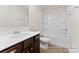 Bright bathroom featuring a tub-shower combination, vanity with solid surface top, and dark wood cabinets at 133 Stonewater Dr # 16P, Red Cross, NC 28129
