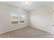 Bright bedroom features carpet flooring and a window providing natural light at 133 Stonewater Dr # 16P, Red Cross, NC 28129