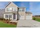 Charming two-story home with a two-car garage, landscaped front yard, and welcoming entrance at 133 Stonewater Dr # 16P, Red Cross, NC 28129