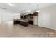 Modern open kitchen with dark cabinets, stainless appliances, island, and spacious layout at 133 Stonewater Dr # 16P, Red Cross, NC 28129