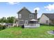 Backyard view of the house, deck, grill, and a spacious grassy area at 1358 Colwick Ln, Rock Hill, SC 29732