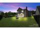 Backyard view featuring a well-maintained lawn, patio, fire pit, and landscaping at 1358 Colwick Ln, Rock Hill, SC 29732