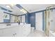 Bright bathroom featuring double sinks with white cabinets, blue walls, and a glass enclosed shower at 1358 Colwick Ln, Rock Hill, SC 29732