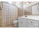 Bathroom with patterned wallpaper, a single sink vanity, toilet, and a shower with patterned curtain at 1358 Colwick Ln, Rock Hill, SC 29732