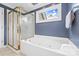 Bathroom showcasing a large soaking tub beneath a window and an adjacent glass enclosed shower at 1358 Colwick Ln, Rock Hill, SC 29732