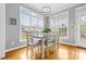 Bright dining room with multiple windows, hardwood floors, and a modern chandelier at 1358 Colwick Ln, Rock Hill, SC 29732
