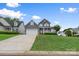 Charming two-story home with welcoming front porch, neutral siding, a two-car garage and a lush, sloped front yard at 1358 Colwick Ln, Rock Hill, SC 29732