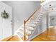 Inviting home foyer features hardwood floors, staircase, and an entry door adorned with a decorative wreath at 1358 Colwick Ln, Rock Hill, SC 29732