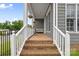 Inviting front porch with brick steps, a bench, hanging plants, and a view of the front yard at 1358 Colwick Ln, Rock Hill, SC 29732