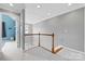 Well-lit hallway with hardwood railing and neutral tones leading to the bedrooms at 1358 Colwick Ln, Rock Hill, SC 29732