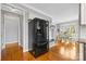 Open-concept kitchen and dining area with hardwood floors and modern black refrigerator at 1358 Colwick Ln, Rock Hill, SC 29732