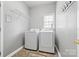 Functional laundry room with modern washer and dryer units, plus wire rack shelving at 1358 Colwick Ln, Rock Hill, SC 29732