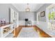 Bright home office with hardwood floors, wainscoting, crown molding, and ample natural light from multiple windows at 1358 Colwick Ln, Rock Hill, SC 29732