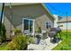 Backyard patio features outdoor seating, a grill, and string lights, ideal for outdoor dining and relaxation at 15813 Capps Rd, Charlotte, NC 28278