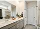 Modern bathroom featuring double sinks, gray cabinetry, and a glass-enclosed shower, offering a spa-like experience at 15813 Capps Rd, Charlotte, NC 28278