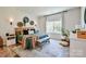 Stylish bedroom featuring a large window, unique wall decor, and a comfortable bed with decorative pillows at 15813 Capps Rd, Charlotte, NC 28278