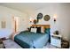 Inviting bedroom boasts a bed with decorative pillows, sconces, a stylish bench, and tasteful wall decorations at 15813 Capps Rd, Charlotte, NC 28278